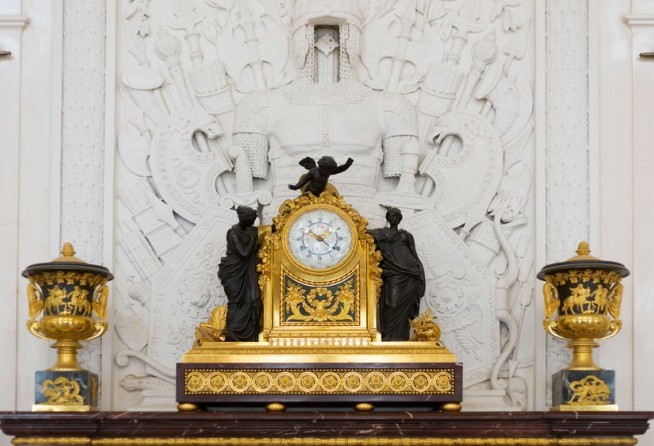 Antique clock in gold case in the interior of the Hermitage